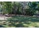 Large backyard with mature trees, lawn, and landscaping at 4042 Shady Nw Cir, Lilburn, GA 30047