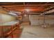 Unfinished basement with concrete walls and floor, exposed wood ceiling, and work bench at 4042 Shady Nw Cir, Lilburn, GA 30047