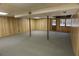 A partially finished basement featuring paneling, support beams, and access to the backyard at 4042 Shady Nw Cir, Lilburn, GA 30047