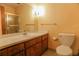 A bathroom featuring a single sink vanity, toilet, mirror and shower with glass door at 4042 Shady Nw Cir, Lilburn, GA 30047