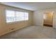 Bright bedroom with a large window, plush carpeting, and neutral wall tones at 4042 Shady Nw Cir, Lilburn, GA 30047