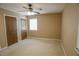 A bedroom with a window and closet with folding doors, illuminated by a ceiling fan at 4042 Shady Nw Cir, Lilburn, GA 30047