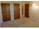 A bedroom with 2 door closet and a lamp illuminating the space at 4042 Shady Nw Cir, Lilburn, GA 30047