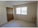 Bedroom with carpeted floor, a window, and a closet with folding doors at 4042 Shady Nw Cir, Lilburn, GA 30047