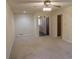 Neutral living room showcasing a ceiling fan and access to other rooms at 4042 Shady Nw Cir, Lilburn, GA 30047