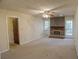 Cozy living room featuring a classic brick fireplace and neutral carpeting at 4042 Shady Nw Cir, Lilburn, GA 30047