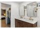 Bathroom showcasing double sinks, quartz countertops, and views into the ensuite bedroom and shower at 410 Wilkinson Se Dr, Atlanta, GA 30317