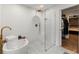 Beautiful bathroom featuring a modern tub, glass-enclosed shower, and mosaic tile flooring at 410 Wilkinson Se Dr, Atlanta, GA 30317