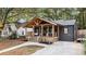 Charming renovated home with a inviting front porch, complemented by mature trees and landscaped yard at 410 Wilkinson Se Dr, Atlanta, GA 30317