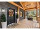 Close up of front door, covered front porch with stained wood details at 410 Wilkinson Se Dr, Atlanta, GA 30317