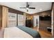 The spacious main bedroom has wood floors, a ceiling fan, and modern black furniture at 410 Wilkinson Se Dr, Atlanta, GA 30317