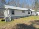 View of the side and front of single-story home with deck and large yard at 7301 Staton Pl, Acworth, GA 30102