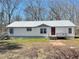 Charming single-story home with white siding, metal roof, and inviting front porch at 7301 Staton Pl, Acworth, GA 30102