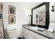 Cozy bathroom featuring a granite countertop, a black-framed mirror, and unique decorative wall art at 1421 Peachtree Ne St # 415, Atlanta, GA 30309