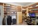 Organized walk-in closet with custom built-in storage solutions, including shelving, drawers, and a desk at 1421 Peachtree Ne St # 415, Atlanta, GA 30309