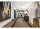 Well-lit hallway featuring a long bench, artwork, and mirrored wall that add depth to the space at 1421 Peachtree Ne St # 415, Atlanta, GA 30309