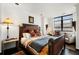 Comfortable main bedroom with luxury bedding, dark floors, window, and reading nook at 1421 Peachtree Ne St # 415, Atlanta, GA 30309