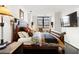 Comfortable main bedroom with luxury bedding, dark floors and a mounted television at 1421 Peachtree Ne St # 415, Atlanta, GA 30309