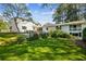 Expansive backyard with lush green lawn, mature trees, and a stone patio area at 1664 West Wesley Nw Rd, Atlanta, GA 30327