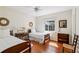 Charming bedroom with hardwood floors, twin beds, and light from the window at 1664 West Wesley Nw Rd, Atlanta, GA 30327