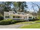 Charming single-story home boasts a white picket fence, manicured lawn, and inviting front porch at 1664 West Wesley Nw Rd, Atlanta, GA 30327