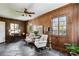 Comfortable living room featuring wood walls, stone floors, and an abundance of natural light at 1664 West Wesley Nw Rd, Atlanta, GA 30327