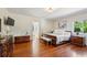 Spacious main bedroom with hardwood floors, a large bed, and natural light from the window at 1664 West Wesley Nw Rd, Atlanta, GA 30327