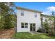 Backyard featuring a small grass lawn and a patio with a gated glass door at 2113 Pine Tree Trl, Atlanta, GA 30349