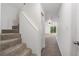 Bright hallway with carpeted stairs leading to an open living area with lots of natural light at 2113 Pine Tree Trl, Atlanta, GA 30349
