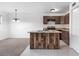 Bright open kitchen featuring stainless appliances, wood island, and a view into the living space at 2113 Pine Tree Trl, Atlanta, GA 30349