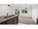 Kitchen with stainless faucet, granite countertop, and chandelier lighting the dining area at 2113 Pine Tree Trl, Atlanta, GA 30349