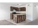 A modern kitchen features stainless appliances, a wood-clad kitchen island and tiled flooring at 2113 Pine Tree Trl, Atlanta, GA 30349