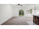 Bright living room features a ceiling fan and sliding door access to the backyard at 2113 Pine Tree Trl, Atlanta, GA 30349