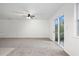 Bright living room features a ceiling fan and sliding door access to the backyard at 2113 Pine Tree Trl, Atlanta, GA 30349