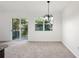 Bright living room featuring a modern light fixture and sliding door access to the backyard at 2113 Pine Tree Trl, Atlanta, GA 30349