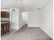 A bright living room area has neutral paint and carpet along with view of the kitchen at 2113 Pine Tree Trl, Atlanta, GA 30349