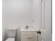 Small powder room featuring a toilet and a sink with a white cabinet at 2113 Pine Tree Trl, Atlanta, GA 30349