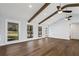 Spacious living room with wood floors, exposed beams, and large windows offering outdoor views at 4178 Castle Pines Ct, Tucker, GA 30084