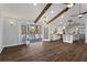 Bright living room with wood floors, exposed beams, open to kitchen with stainless steel appliances and island at 4178 Castle Pines Ct, Tucker, GA 30084