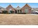 Charming brick ranch home with manicured landscaping, arched windows, and attached garage at 970 Prance Dr, Kennesaw, GA 30144