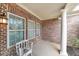 Cozy porch with brick walls and a white column, perfect for enjoying quiet moments outdoors at 970 Prance Dr, Kennesaw, GA 30144