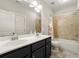 Bathroom featuring double sink vanity with dark cabinets, large mirror, and a shower-tub combination at 1818 Cromwell Walk, Dunwoody, GA 30338