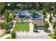 A well-maintained playground with colorful equipment, sun shades, seating, and landscaped areas in a community park setting at 1818 Cromwell Walk, Dunwoody, GA 30338