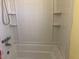 Bright bathroom with a shower-tub combo featuring built-in shelving at 23 Holub Path, Dallas, GA 30157