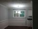 Dining room with wainscoting, a chandelier, and natural light from a large window at 23 Holub Path, Dallas, GA 30157