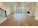 Bright, open living room with hardwood floors, stone fireplace, and French doors leading to the outdoors at 2400 Edgar Park Pl # 103, Duluth, GA 30096