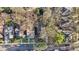 Overhead neighborhood view shows a brown house nestled in trees, highlighting the layout of adjacent homes and green surroundings at 313 5Th Ne St, Atlanta, GA 30308