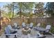 Charming backyard featuring a fire pit surrounded by Adirondack chairs, ideal for cozy outdoor gatherings at 313 5Th Ne St, Atlanta, GA 30308