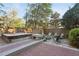 Backyard featuring a hot tub, fire pit with chairs, and a wooden deck surrounded by lush greenery at 313 5Th Ne St, Atlanta, GA 30308