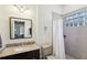 Bathroom featuring a tub/shower with glass block and granite vanity with dark wood cabinets at 313 5Th Ne St, Atlanta, GA 30308